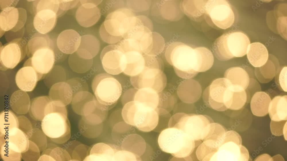 Abstract sea summer ocean sunset nature background. Small waves on golden water surface in motion blur with golden bokeh lights from sun. Holiday, vacation and recreation. Weather and climate change. Abstract sea summer ocean sunset nature background. Small waves on golden water surface in motion blur with golden bokeh lights from sun. Holiday, vacation and recreation. Weather and climate change.