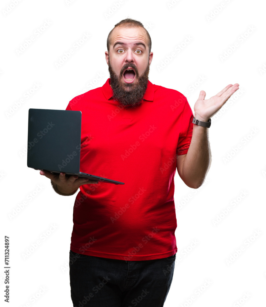 Young caucasian man using computer laptop over isolated background very happy and excited, winner expression celebrating victory screaming with big smile and raised hands Young caucasian man using computer laptop over isolated background very happy and excited, winner expression celebrating victory screaming with big smile and raised hands