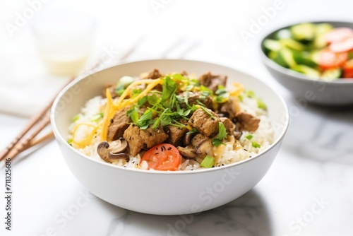 beef shawarma bowl with rice, toppings, and a fork nearby