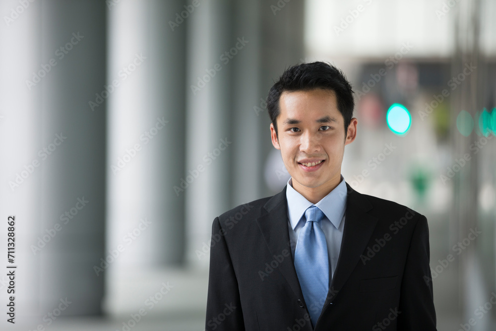 happy young Chinese business man in modern city happy young Chinese business man in modern city