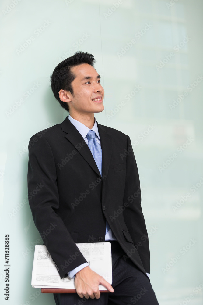 happy young Chinese business man in modern city happy young Chinese business man in modern city