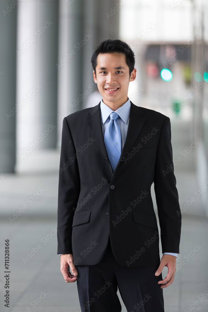 happy young Chinese business man in modern city happy young Chinese business man in modern city