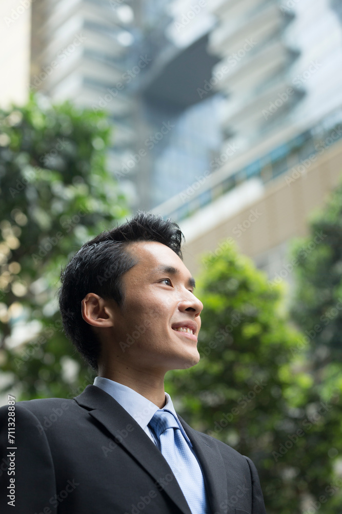 happy young Chinese business man in modern city happy young Chinese business man in modern city