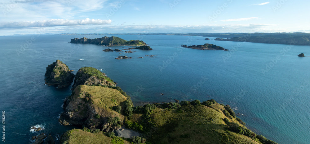 Island off the coast of Matauri Bay at sunset Bay of Islands, Northland, New Zealand. Island off the coast of Matauri Bay at sunset Bay of Islands, Northland, New Zealand.