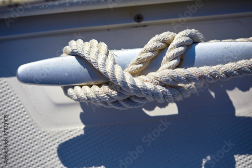 Detail of a mooring rope placed on sailing boat yacht desk
