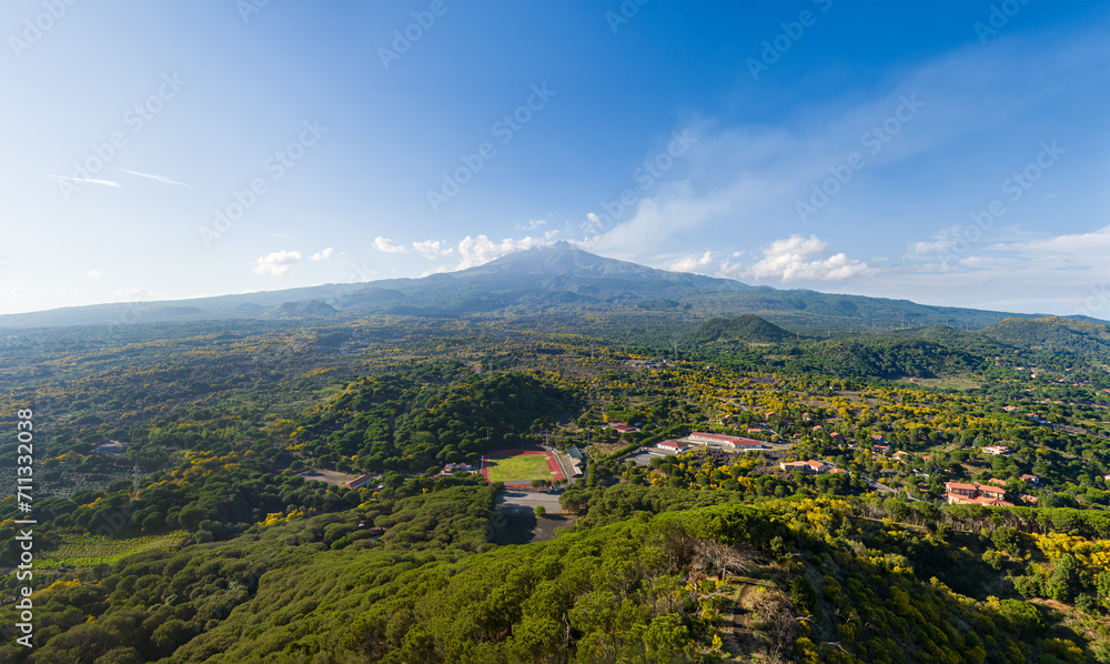 Nicolosi, Sicily, Italy. Volcanic craters overgrown with forest on the slopes of Mount Etna. Aerial view