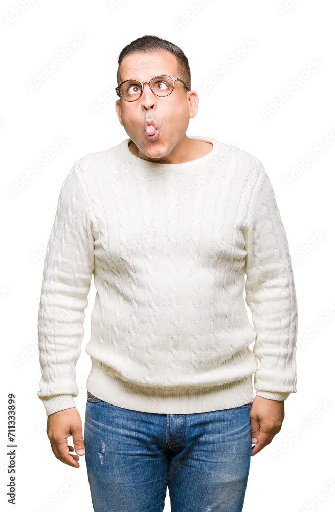 Middle age arab man wearing glasses over isolated background making fish face with lips, crazy and comical gesture. Funny expression. Middle age arab man wearing glasses over isolated background making fish face with lips, crazy and comical gesture. Funny expression.