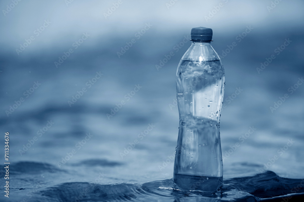 A bottle of pure water on water background A bottle of pure water on water background