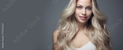 Portrait of a beautiful, sexy Caucasian woman with perfect skin and white long hair, on a silver background.