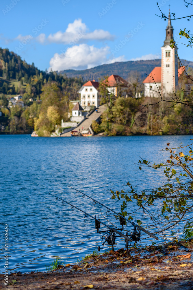 Fishing rods on shore of lake Bled on an autumn day in Slovenia