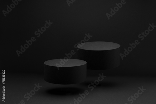 Two black round soaring podiums, set, mockup on black background, shadow. Template for presentation cosmetic products, gifts, goods, advertising, design, display, showing in exquisite modern style.