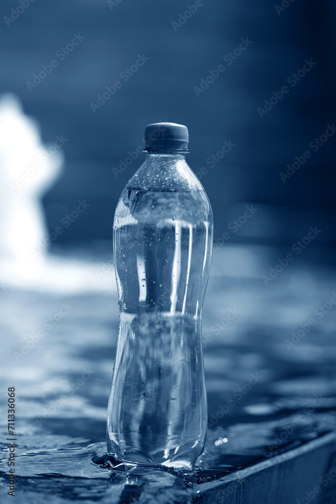 A bottle of pure water on water background