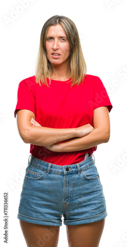 Young beautiful woman over isolated background skeptic and nervous, disapproving expression on face with crossed arms. Negative person.