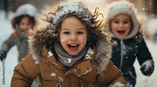 Group of children playing on snow in winter time. Long banner format