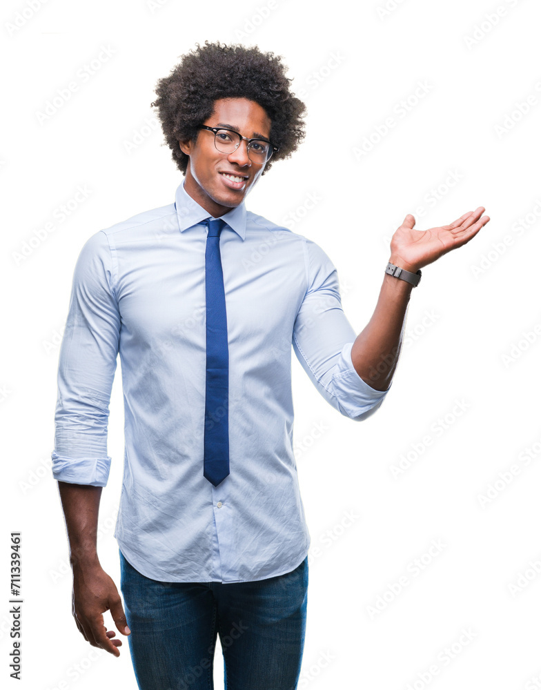 Afro american business man wearing glasses over isolated background smiling cheerful presenting and pointing with palm of hand looking at the camera. Afro american business man wearing glasses over isolated background smiling cheerful presenting and pointing with palm of hand looking at the camera.