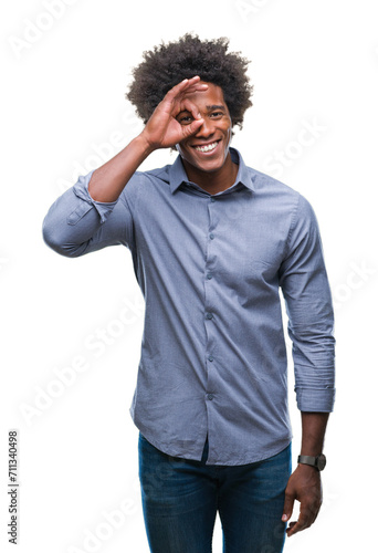 Afro american man over isolated background doing ok gesture with hand smiling, eye looking through fingers with happy face.