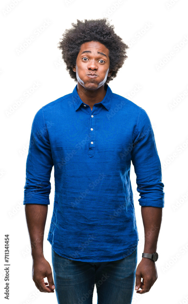 Afro american man over isolated background puffing cheeks with funny face. Mouth inflated with air, crazy expression. - obrazy, fototapety, plakaty 