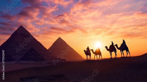 Silhouettes of camels against the background of the pyramids.