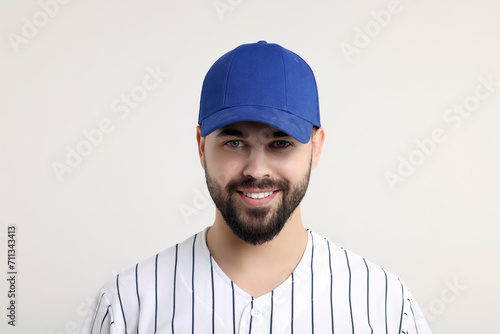 Man in stylish blue baseball cap on white background photo