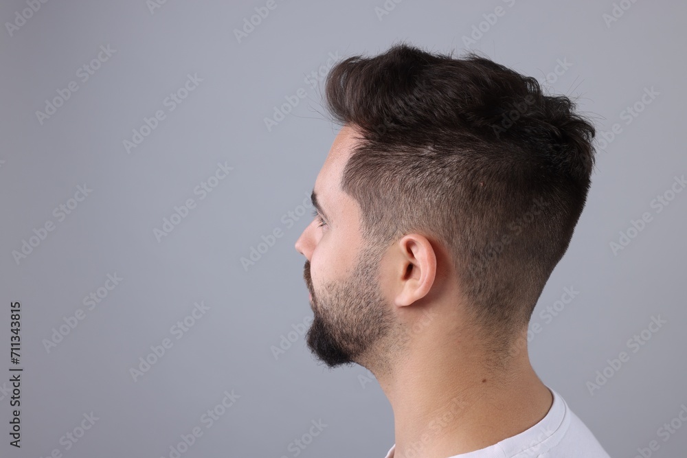 Man with healthy hair on light grey background, space for text
