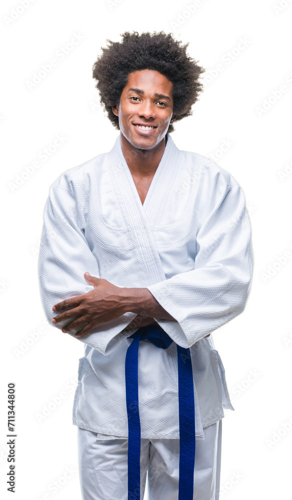 Afro american man wearing karate kimono over isolated background happy face smiling with crossed arms looking at the camera. Positive person. Afro american man wearing karate kimono over isolated background happy face smiling with crossed arms looking at the camera. Positive person.