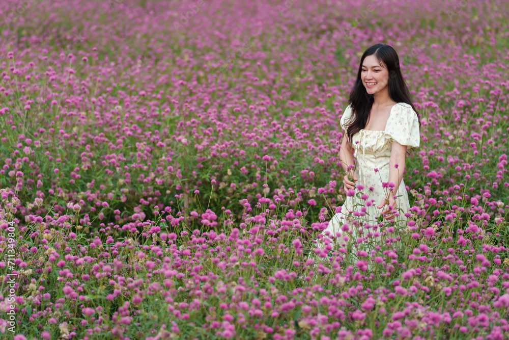 beautiful woman in dress enjoying blooming pink globe amaranth or bachelor button field beautiful woman in dress enjoying blooming pink globe amaranth or bachelor button field
