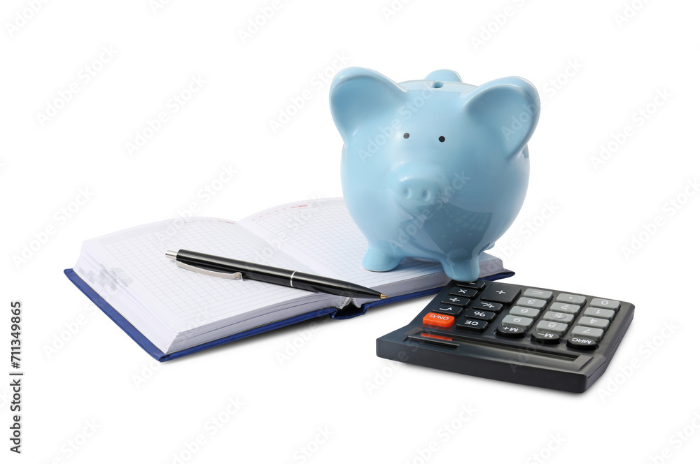 Calculator, piggy bank, pen and notebook isolated on white Calculator, piggy bank, pen and notebook isolated on white