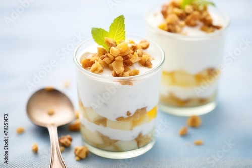 greek yogurt with layered date pieces and walnuts, close-up shot
