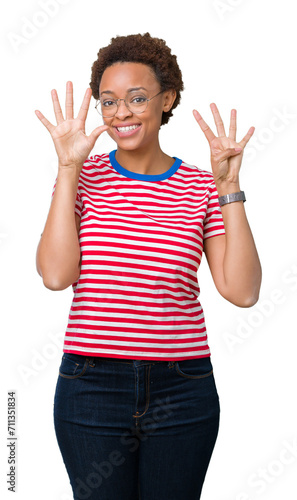 Beautiful young african american woman wearing glasses over isolated background showing and pointing up with fingers number nine while smiling confident and happy.