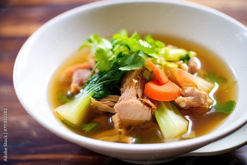 hot and sour soup with sliced pork floating amongst vegetables hot and sour soup with sliced pork floating amongst vegetables
