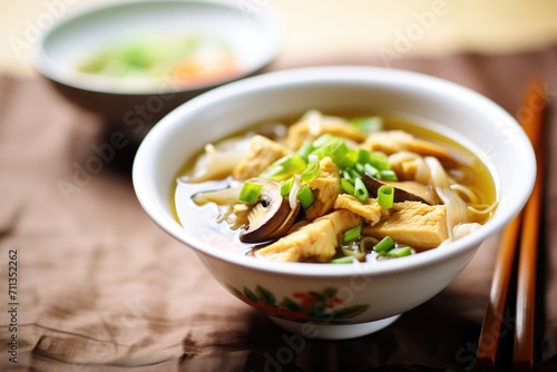 hot and sour soup with tofu and mushrooms visible