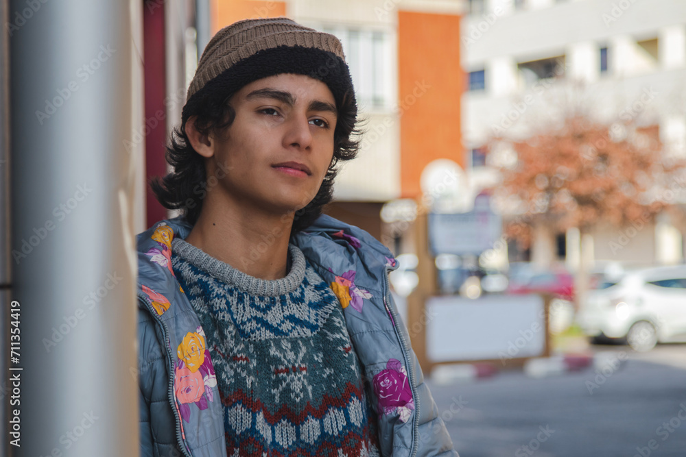 urban hispanic latin young man on street wall