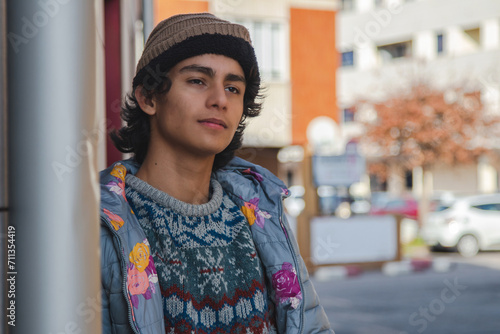 urban hispanic latin young man on street wall