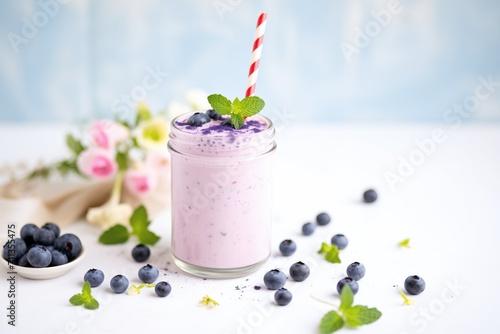 blueberry milkshake with fresh blueberries and mint sprig