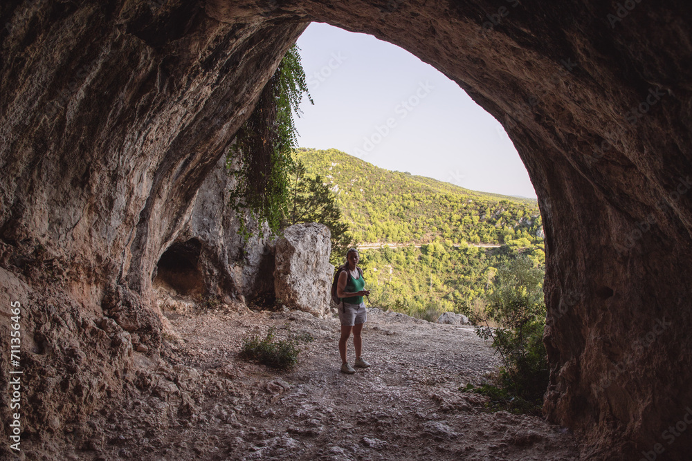 woman tourist exploring a cave