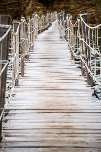 wooden footbridge leading to the small island of Agios Sostis on Zakynthos  Greece  during a sunny summer day