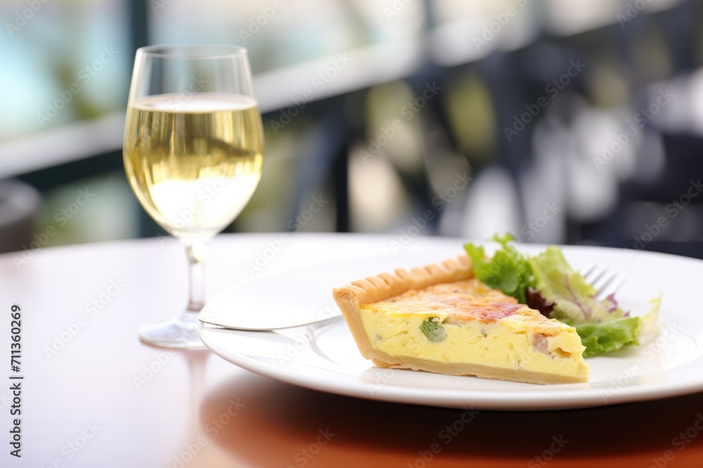 quiche lorraine with a glass of white wine for lunch
