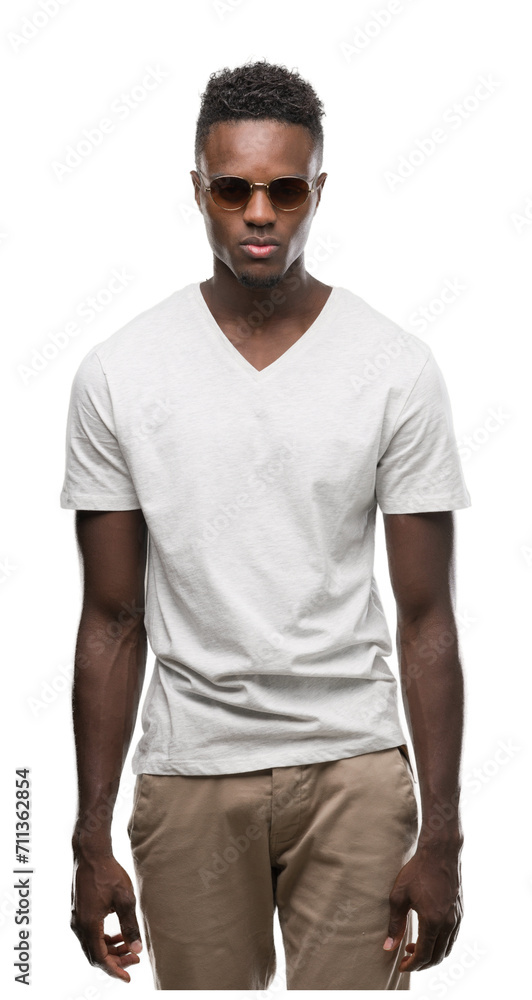Young african american man wearing sunglasses with a confident expression on smart face thinking serious Young african american man wearing sunglasses with a confident expression on smart face thinking serious