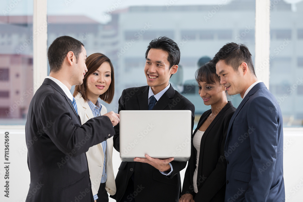 business team working together around a laptop business team working together around a laptop