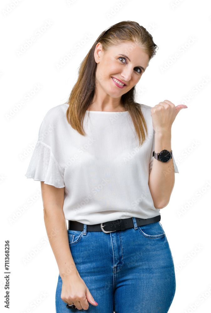 Middle age mature beautiful woman over isolated background smiling with happy face looking and pointing to the side with thumb up. Middle age mature beautiful woman over isolated background smiling with happy face looking and pointing to the side with thumb up.