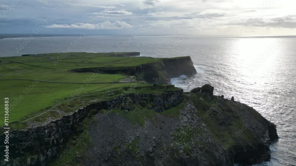 Aerial tilting shot of a crumbling watchtower at the Cliffs of Moher Aerial tilting shot of a crumbling watchtower at the Cliffs of Moher