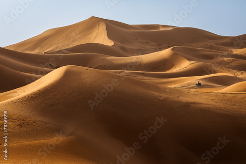 ATV machine running on desert dunes in Sahara, Merzouga, Morocco