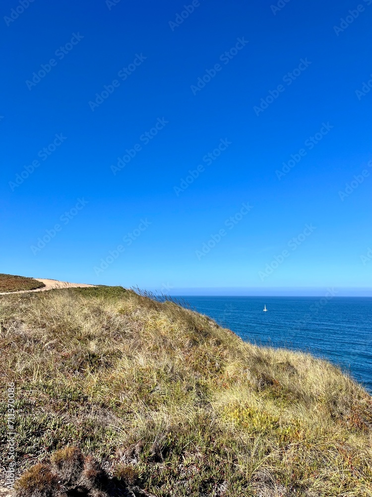 Ocean coast, clear blue sky, blue horizon, natural colors, no people Ocean coast, clear blue sky, blue horizon, natural colors, no people