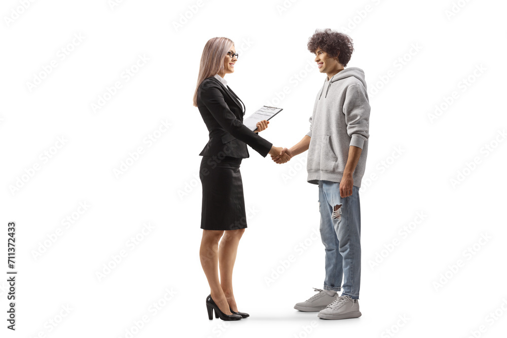 Full length profile shot of a young casual man shaking hands with a businesswoman Full length profile shot of a young casual man shaking hands with a businesswoman
