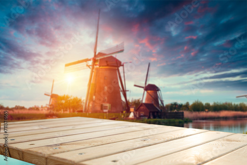 Canvas Print Beautiful Dutch scenery with traditional windmills and tulip flowers foreground