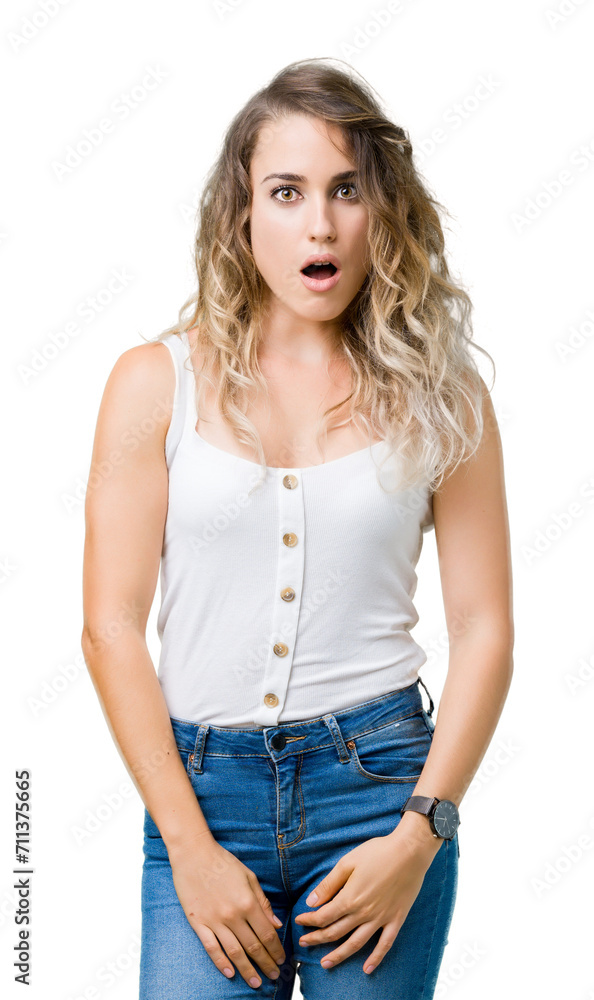 Young beautiful blonde woman over isolated background afraid and shocked with surprise expression, fear and excited face. Young beautiful blonde woman over isolated background afraid and shocked with surprise expression, fear and excited face.
