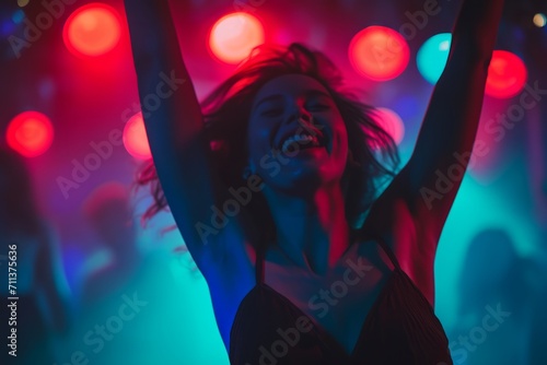 Joyful woman dancing at a club with vibrant lights and festive atmosphere.
