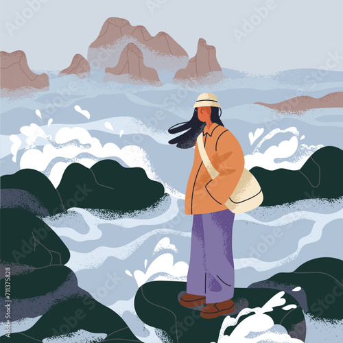 Woman at sea in windy cold weather. Sad person thinking, standing on rock, st...