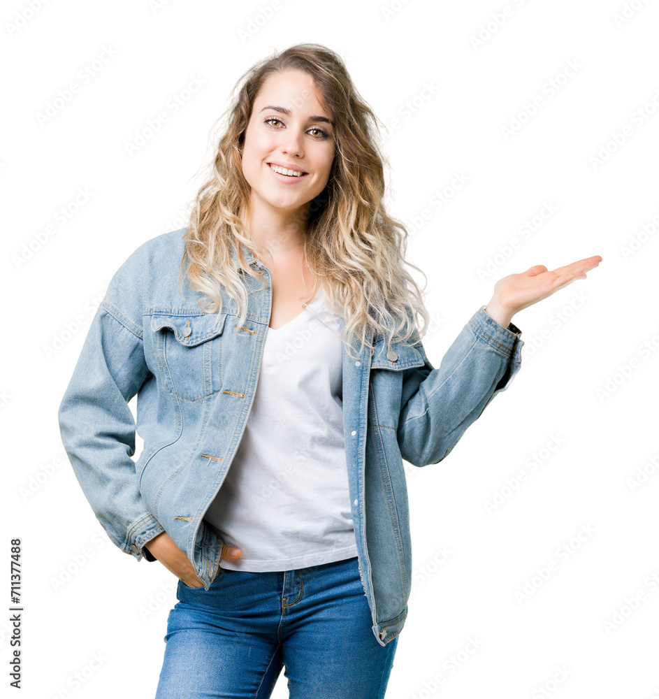 Beautiful young blonde woman wearing denim jacket over isolated background smiling cheerful presenting and pointing with palm of hand looking at the camera. Beautiful young blonde woman wearing denim jacket over isolated background smiling cheerful presenting and pointing with palm of hand looking at the camera.