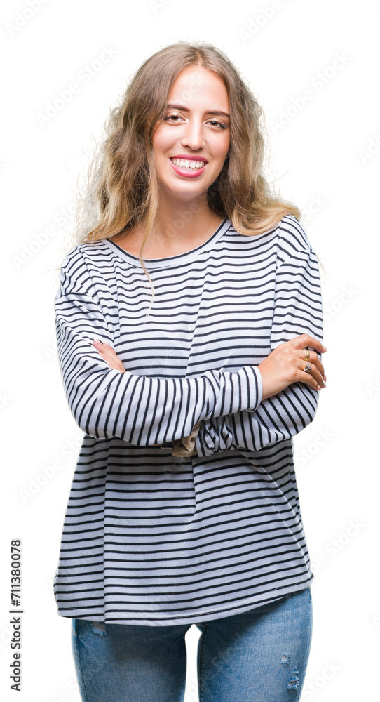 Beautiful young blonde woman wearing stripes sweater over isolated background happy face smiling with crossed arms looking at the camera. Positive person. Beautiful young blonde woman wearing stripes sweater over isolated background happy face smiling with crossed arms looking at the camera. Positive person.